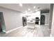 Open concept kitchen with stainless steel appliances and a kitchen island overlooking the living area at 926 Freshmeadow Ct, Apopka, FL 32703