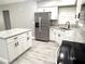 Well-appointed kitchen with granite counters, stainless appliances, and sleek white cabinets at 926 Freshmeadow Ct, Apopka, FL 32703