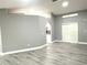 Open-concept living area with modern gray walls, light wood-look flooring, and an arched entryway at 926 Freshmeadow Ct, Apopka, FL 32703