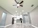 Open-concept living room with vaulted ceilings and view into the kitchen with modern appliances at 926 Freshmeadow Ct, Apopka, FL 32703