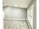 Large living area with modern gray walls, recessed lights, and wood-look flooring at 926 Freshmeadow Ct, Apopka, FL 32703