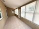Enclosed sunroom featuring large windows and neutral tile flooring at 926 Freshmeadow Ct, Apopka, FL 32703