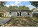 Back of home showing patio doors surrounded by two small windows looking out onto the spacious backyard at 979 Mayfair St, Eustis, FL 32726