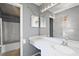 Bathroom features a vanity, a sink, a mirror, a toilet, and a shower with gray walls at 979 Mayfair St, Eustis, FL 32726