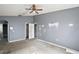 Spacious bedroom with vaulted ceiling, ceiling fan and ensuite bath through arched doorway at 979 Mayfair St, Eustis, FL 32726