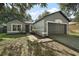 Charming single-story home with a well-maintained front yard and attached two-car garage at 979 Mayfair St, Eustis, FL 32726