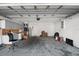 A cluttered garage space with overhead lighting and a concrete floor at 979 Mayfair St, Eustis, FL 32726