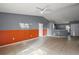 A spacious living room featuring tile flooring, gray and orange accent walls and an open floor plan at 979 Mayfair St, Eustis, FL 32726