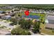 Overhead view of a residential neighborhood showcasing the home's position on a beautiful pond at 1111 Liberty Hall Dr, Kissimmee, FL 34746