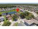 Aerial view of a beautiful home with lush landscaping and a pond in a serene neighborhood with mature trees at 1111 Liberty Hall Dr, Kissimmee, FL 34746