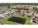 An aerial view of a beautiful home with a screened-in pool in a neighborhood with mature trees and multiple ponds at 1111 Liberty Hall Dr, Kissimmee, FL 34746