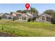The backyard features a screened-in pool, lush grass, and a view of a pond in a serene neighborhood at 1111 Liberty Hall Dr, Kissimmee, FL 34746