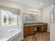 Bathroom featuring granite countertop vanity, soaking tub, and walk-in shower at 1111 Liberty Hall Dr, Kissimmee, FL 34746