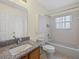 Bathroom featuring a granite vanity, tub with shower, and ceramic tile flooring at 1111 Liberty Hall Dr, Kissimmee, FL 34746