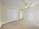 Bedroom featuring neutral carpet, a ceiling fan, and a large closet at 1111 Liberty Hall Dr, Kissimmee, FL 34746