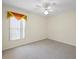 Inviting bedroom featuring a ceiling fan, plush carpet, and a sunny window at 1111 Liberty Hall Dr, Kissimmee, FL 34746