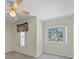 Bright bedroom with a ceiling fan and natural light streaming through the windows at 1111 Liberty Hall Dr, Kissimmee, FL 34746