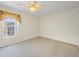 Comfortable bedroom with carpet, ceiling fan, and a window offering natural light at 1111 Liberty Hall Dr, Kissimmee, FL 34746