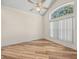 Bright bedroom with window and wood-look flooring; vaulted ceiling at 1111 Liberty Hall Dr, Kissimmee, FL 34746