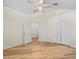 Bedroom with closet and wood-look floors; ceiling fan and natural light at 1111 Liberty Hall Dr, Kissimmee, FL 34746