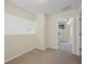 Cozy bedroom featuring neutral carpet, cream walls, and an entrance to another room at 1111 Liberty Hall Dr, Kissimmee, FL 34746