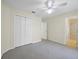 Bedroom featuring a ceiling fan, closet, and an adjacent bathroom entrance at 1111 Liberty Hall Dr, Kissimmee, FL 34746