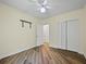 Bedroom with ceiling fan, closet and vinyl flooring with freshly painted neutral colored walls at 1111 Liberty Hall Dr, Kissimmee, FL 34746