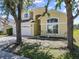 Charming two-story home with a three car garage, arched entryway, and a well-maintained lawn at 1111 Liberty Hall Dr, Kissimmee, FL 34746