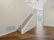 Bright two-story foyer featuring staircase with carpet, wood floors and backyard pool view at 1111 Liberty Hall Dr, Kissimmee, FL 34746