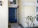 A close-up of the home's entryway, featuring a blue front door with sidelight and decorative hardware at 1111 Liberty Hall Dr, Kissimmee, FL 34746