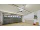 Spacious two car garage featuring panel garage door and utility access at 1111 Liberty Hall Dr, Kissimmee, FL 34746