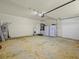 Spacious two car garage featuring painted floors, a utility sink and extra fridge at 1111 Liberty Hall Dr, Kissimmee, FL 34746