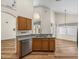 Bright kitchen features stainless steel appliances, granite countertops and wood flooring at 1111 Liberty Hall Dr, Kissimmee, FL 34746