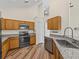 Well-equipped kitchen features granite counters, stainless appliances, and wood-look flooring at 1111 Liberty Hall Dr, Kissimmee, FL 34746