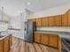 Spacious kitchen featuring two-tone cabinets, stainless steel appliances, and durable granite countertops at 1111 Liberty Hall Dr, Kissimmee, FL 34746