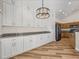 Updated kitchen featuring white cabinets, granite countertops and wood-look floors at 1111 Liberty Hall Dr, Kissimmee, FL 34746