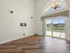 A spacious room with wood floors, large window, and an open floor plan for entertaining and relaxation at 1111 Liberty Hall Dr, Kissimmee, FL 34746