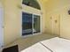Covered patio with a sliding door leading to a pool area, offering outdoor relaxation at 1111 Liberty Hall Dr, Kissimmee, FL 34746