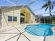 A beautiful screened-in pool with a kidney shape surrounded by a light colored patio perfect for outdoor enjoyment at 1111 Liberty Hall Dr, Kissimmee, FL 34746