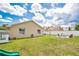 Green backyard with a white fence, fire pit and play structure at 1166 Mapimi Ct, Winter Springs, FL 32708