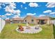 Large backyard featuring a fire pit with seating and ample room for recreation at 1166 Mapimi Ct, Winter Springs, FL 32708