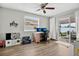 Bright bedroom featuring wood floors, a ceiling fan, and sliding glass doors to the outdoor patio at 1166 Mapimi Ct, Winter Springs, FL 32708