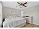 Bedroom with ceiling fan, light grey walls, wood-look flooring and backyard view at 1166 Mapimi Ct, Winter Springs, FL 32708