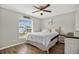Bedroom with ceiling fan, wood-look floors and backyard view at 1166 Mapimi Ct, Winter Springs, FL 32708