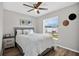 Bedroom with ceiling fan, wood-look floors, and view to backyard seating area at 1166 Mapimi Ct, Winter Springs, FL 32708