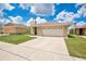 Well-maintained home with a spacious driveway, a two-car garage, and green lawn at 1166 Mapimi Ct, Winter Springs, FL 32708