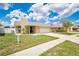 Inviting home featuring a covered entryway, brick accents, and a manicured lawn at 1166 Mapimi Ct, Winter Springs, FL 32708
