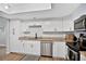 Kitchen with white cabinets, granite countertops and stainless steel dishwasher at 1166 Mapimi Ct, Winter Springs, FL 32708