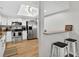 Bright kitchen features white cabinets, stainless steel appliances, breakfast bar and modern lighting at 1166 Mapimi Ct, Winter Springs, FL 32708