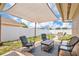 Relaxing outdoor patio area with comfortable seating and shade cover at 1166 Mapimi Ct, Winter Springs, FL 32708